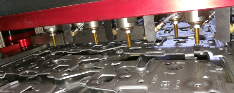 A multi-spindle in-die tapping unit a progressive die